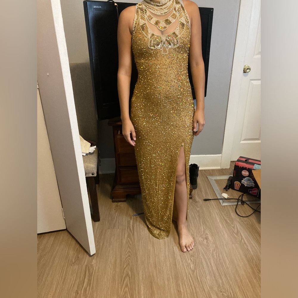This is a beautiful gold Formal Dress. It’s heavy, glass beaded, fits Size 4